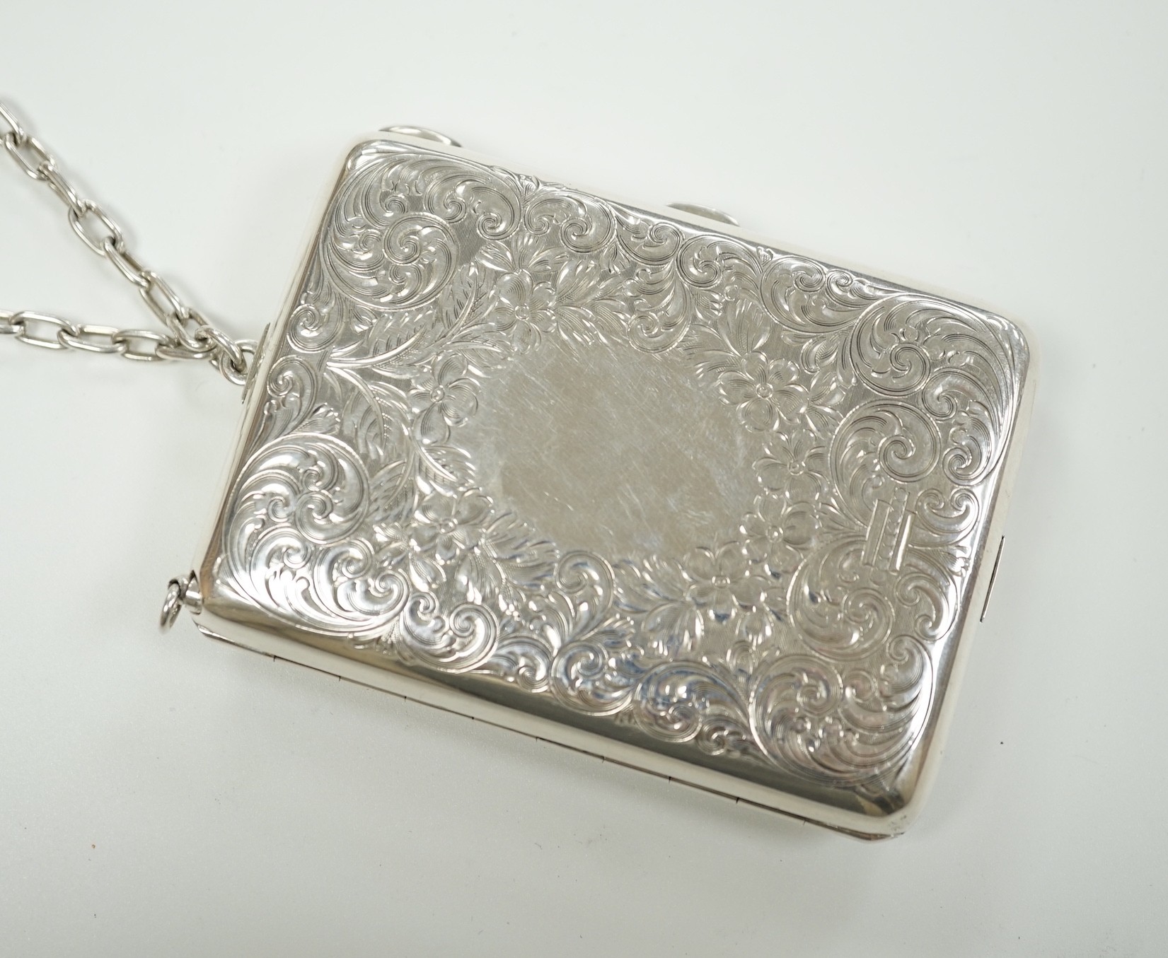 An early 20th century American engraved sterling rounded rectangular combination aide memoir, purse, pill box, sovereign and half sovereign case, by R. Blackinton & Co, with pencil and suspension chain, 88mm.
